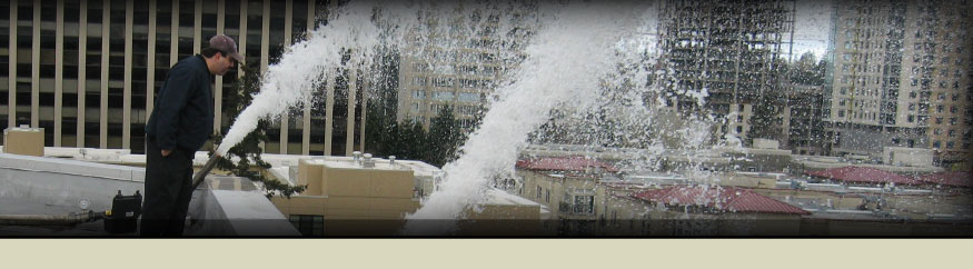 Technician clearing water from a fire sprinkler system